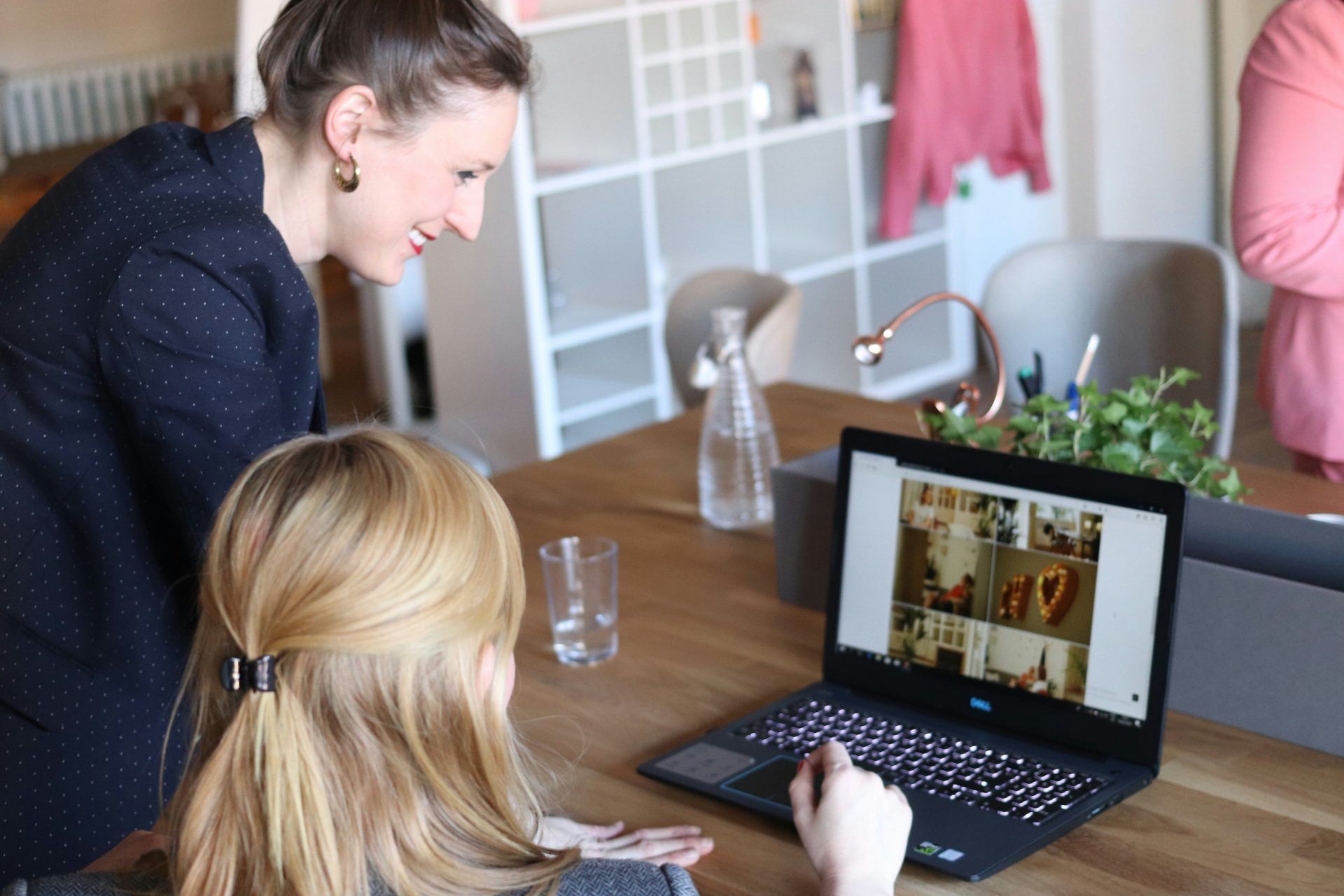 Colleagues collaborating over a laptop display